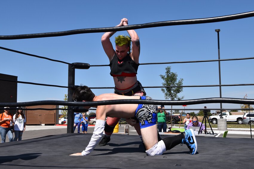 The Fort Lupton Library had a special treat for Trapper Days Sept. 9: Wrestlers performing outside in a ring. Here, Wrestler Kadaver pounds on Type One Warrior for the crowd's entertainment The two are with Primos Premier Pro Wrestling based out of Denver. They have wrestling training programs and run shows.